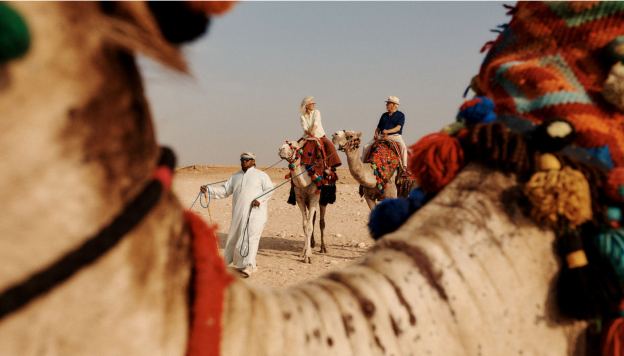 Travellers riding camels.
