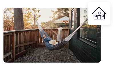 Traveller in hammock outside their holiday home.