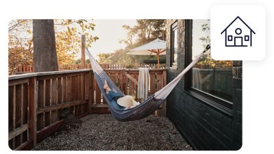 Traveller in hammock outside their holiday home.