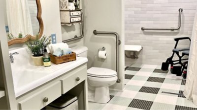 Bathroom with support rails designed for wheelchair accessibility.