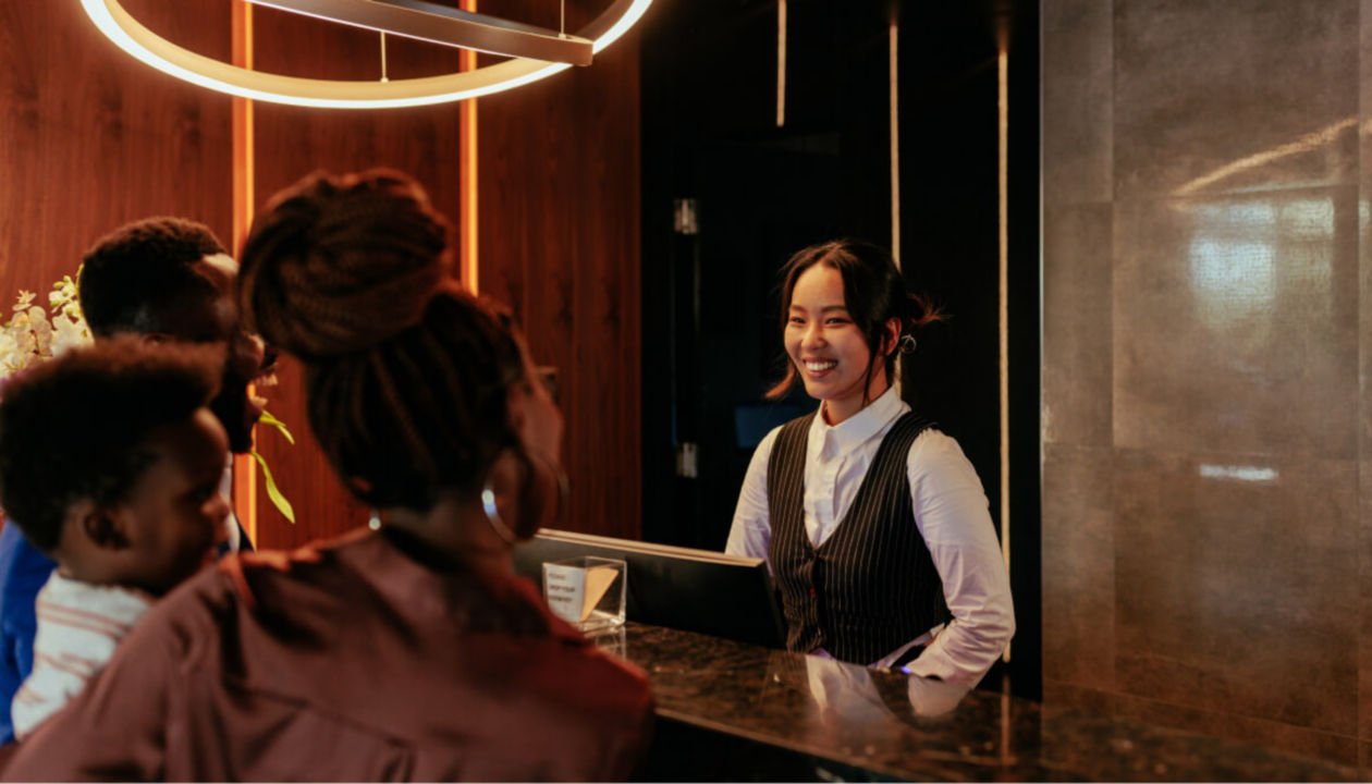 A hotel receptionist helping a family check in