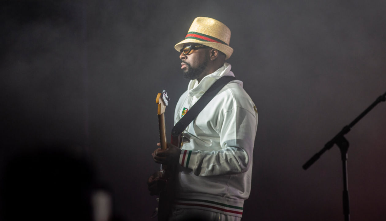 Wyclef Jean playing guitar on stage at Explore 2022