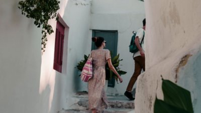 A couple walk up outdoor steps in a European city