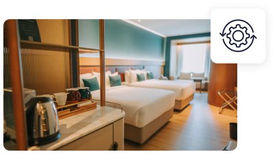 Hotel room photograph with a gear and circular arrows icon overlayed on top depicting automation