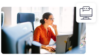 Image of a business woman working at her desk with a chat box icon overlayed on top