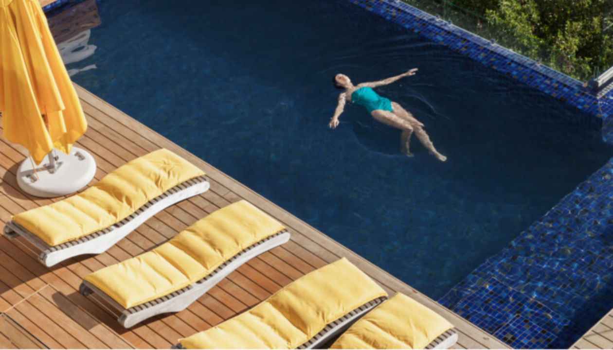 Woman floating in a resort pool 