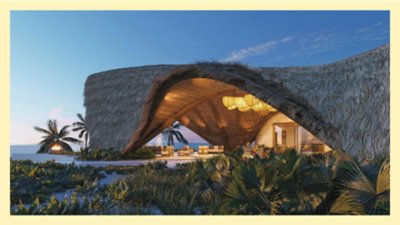  Photograph from a vegetated beach, looking at the lobby of an architecturally interesting luxury resort with a thatched roof.